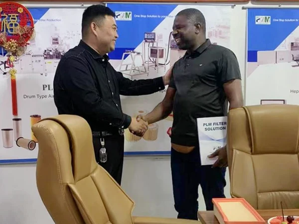 PLM Filter staff is smiling and shaking hands with partners.