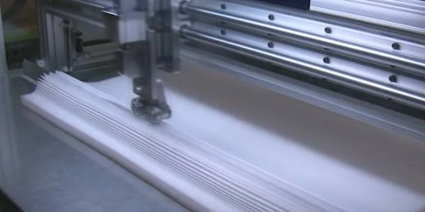 The cutting machine is cutting the filter fabric.