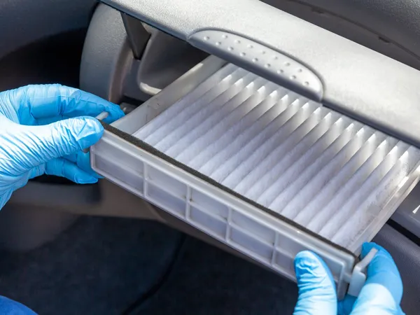 Car cabin air filter installed inside vehicle cabin for clean air.