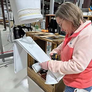 Worker is making dust collector filter bags