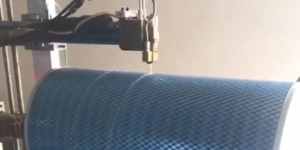The glue dispensing machine is applying glue on dust filter cartridge.
