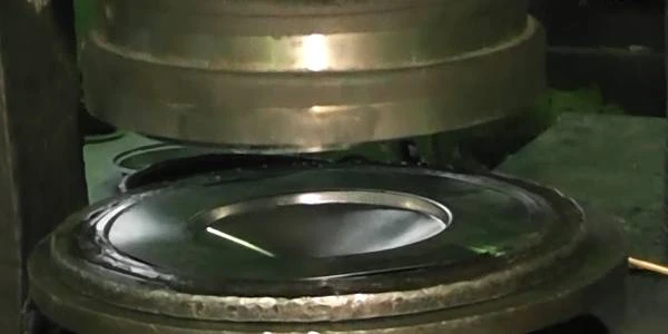 The stamping machine is making metal end cap.