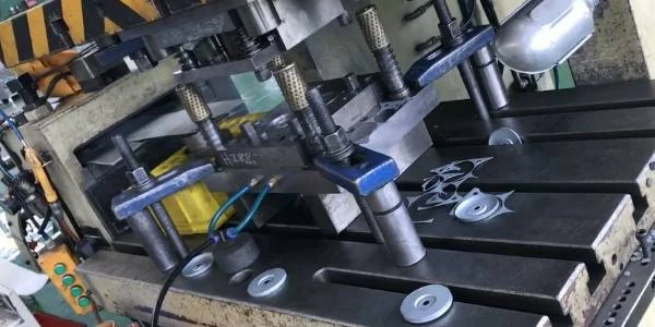 The stamping machine is making metal end cap.