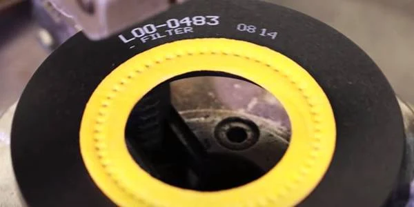 The printing machine is printing on eco-friendly fuel and oil filters.