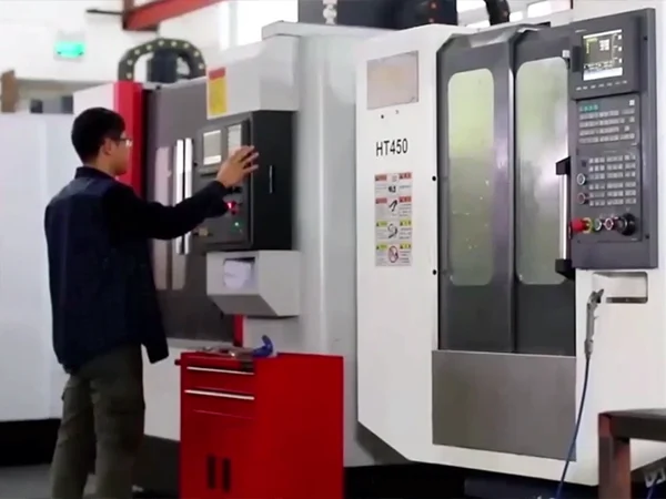 The worker is operating the equipment.