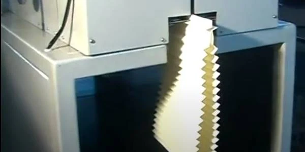 Hot melt adhesive machine is bonding the filter material.