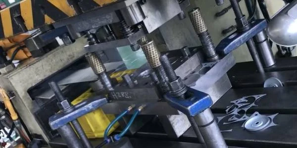 The stamping machine is producing end caps.