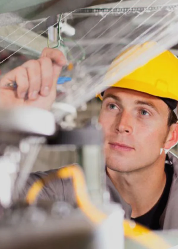 Our employee is inspecting non - woven fabric machinery.