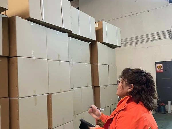 The worker is checking goods packaging.