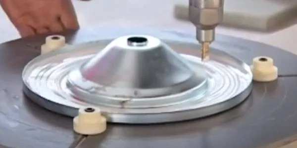 End cap gluing machine applies adhesive to metal end cap.