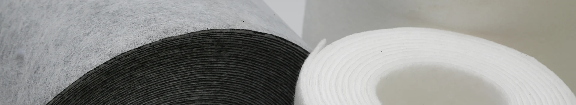 Filter fabric rolls on a gray background
